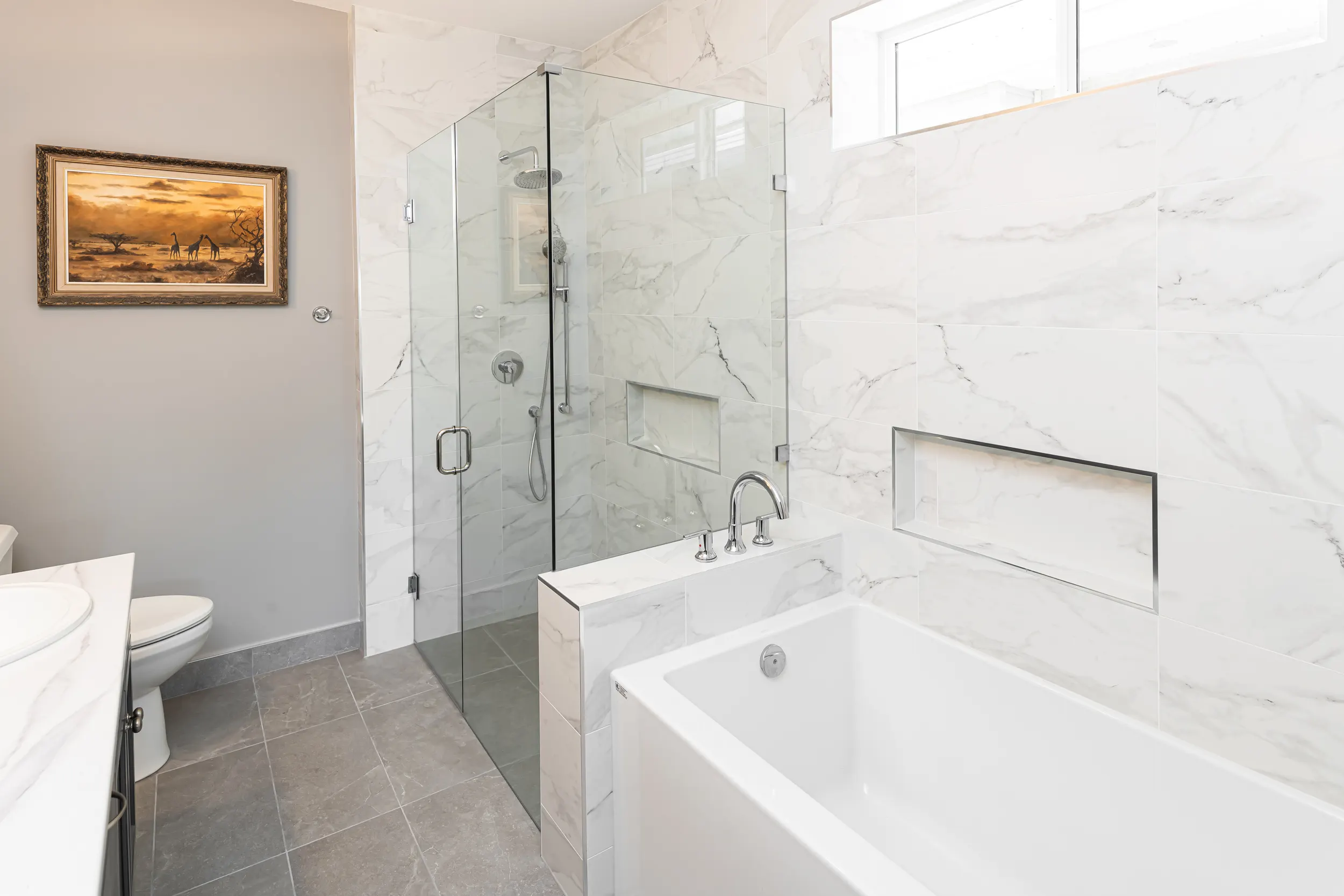 Elegant low-threshold walk-in shower in marble tile by Master Painting & Renovations, Chilliwack BC