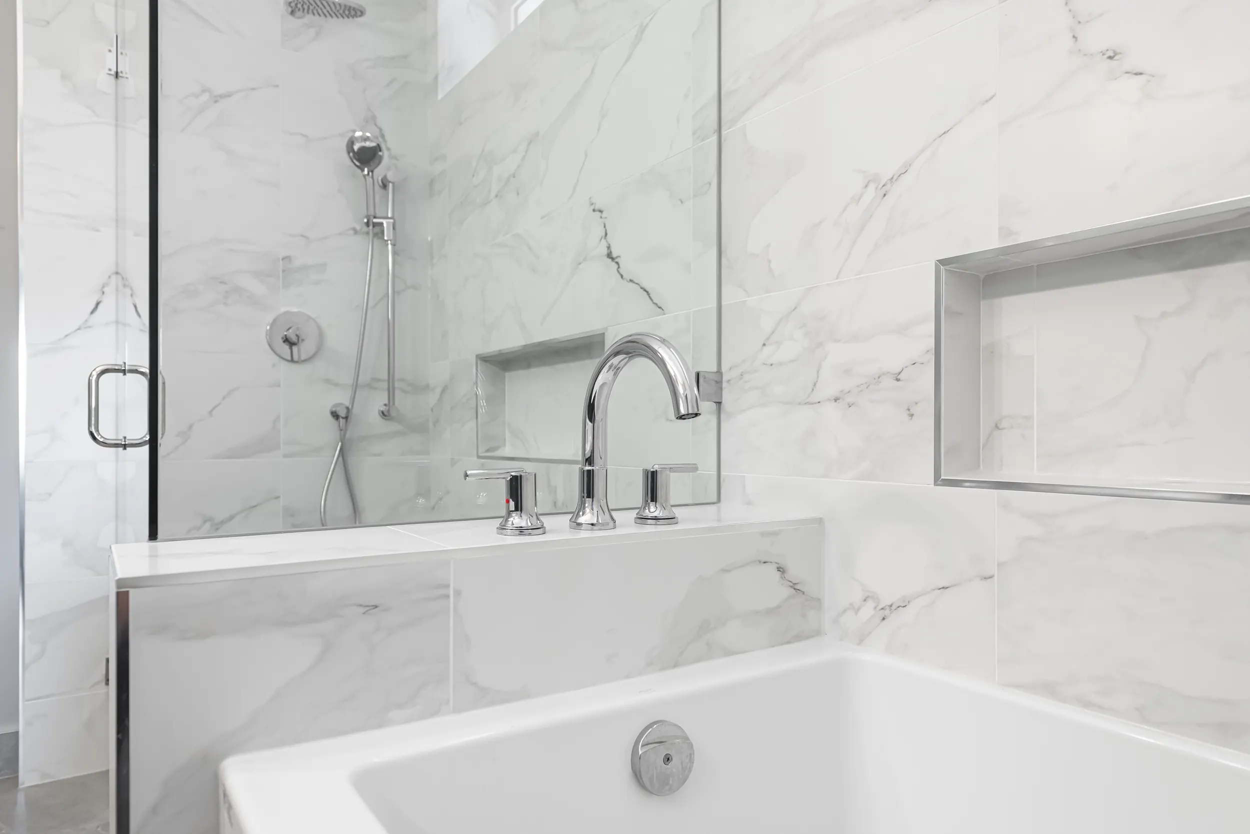 Marble-tiled spa bathroom with soaker tub and glass shower by Master Painting & Renovations, Chilliwack BC