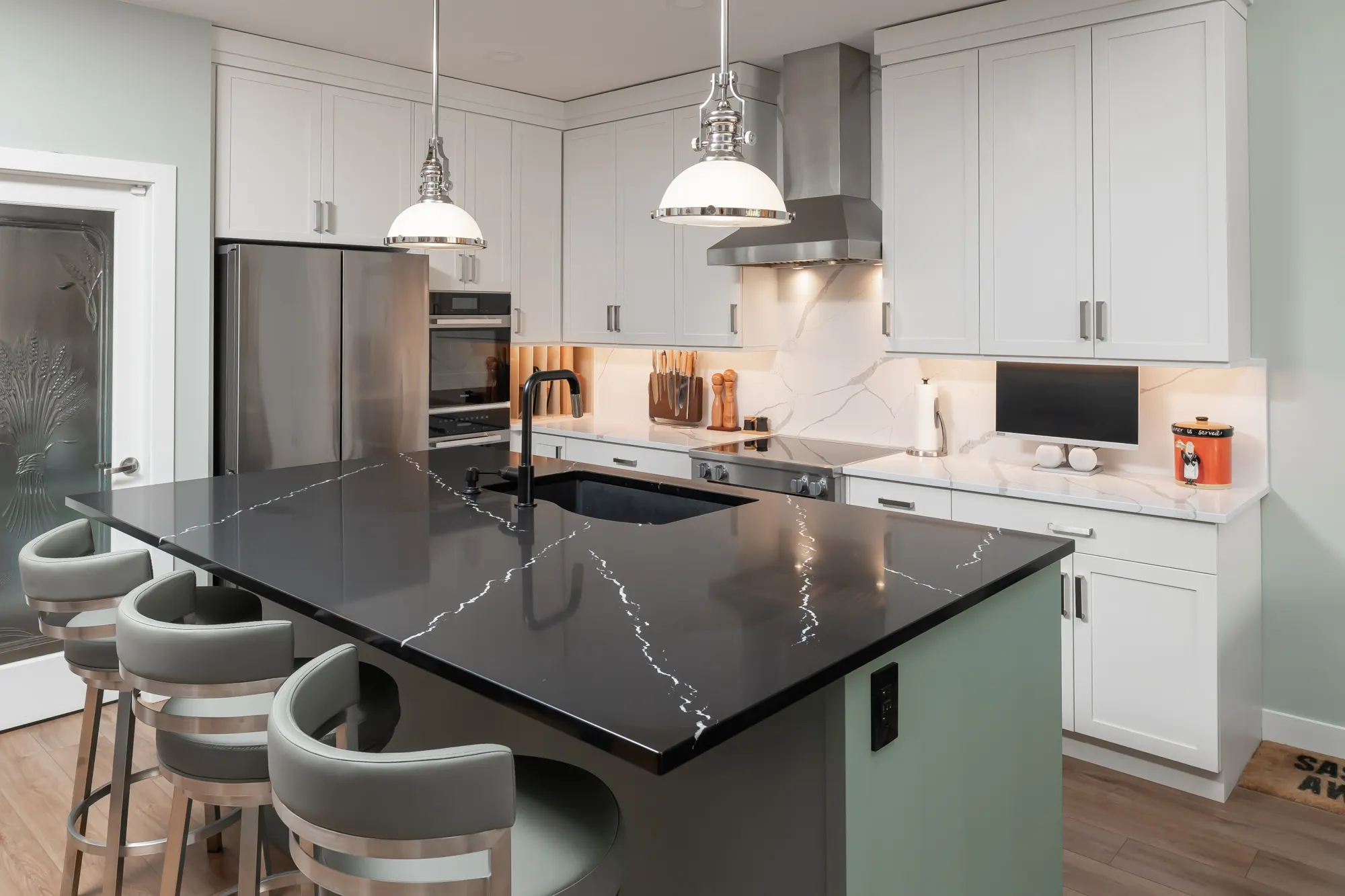 Kitchen renovation with black quartz island and custom cabinetry by Master Painting & Renovations, Chilliwack BC